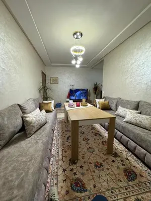 a living room with a couch and a table at Marrakech mahamid location vacances 3 chember in Marrakech