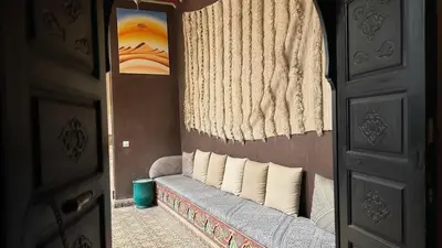 a bedroom with a bed with pillows and a window at Riad Lana Marrakech - Dar el Bacha Luxury Suites in Marrakech