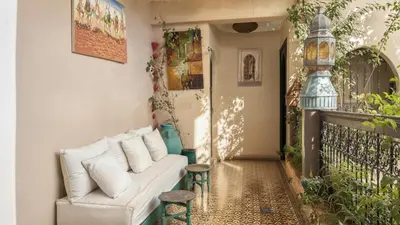 a living room with a couch and some plants at Riad Lana Marrakech - Dar el Bacha Luxury Suites in Marrakech