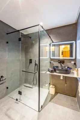 a bathroom with a glass shower and a sink at Le Nid de Guéliz Private terrace and silence in Marrakech