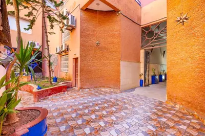 an empty courtyard of a building with a brick wall at Le Nid de Guéliz Private terrace and silence in Marrakech
