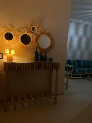 a living room with two mirrors on a table at Cozy flat near airport in Marrakech