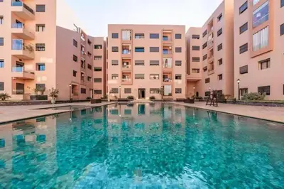 a large swimming pool in front of a building at Jnane El Ali 3 in Marrakech