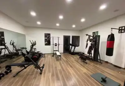 a gym with exercise bikes and tread machines in a room at Jnane El Ali 3 in Marrakech