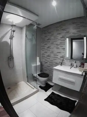 a bathroom with a shower and a toilet and a sink at Jnane El Ali 3 in Marrakech