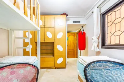 a bedroom with two bunk beds and a closet at Oasis Familiale Marrakech Piscine & Résidence Sécurisée in Marrakech
