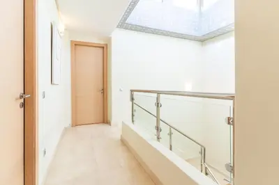 a hallway with a glass railing and a skylight at Private Pool Villa Facing Golf Luxury inMarrakech in Marrakech