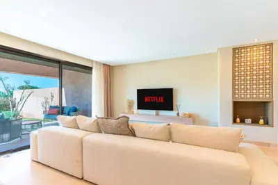 a living room with a couch and a tv at Private Pool Villa Facing Golf Luxury inMarrakech in Marrakech