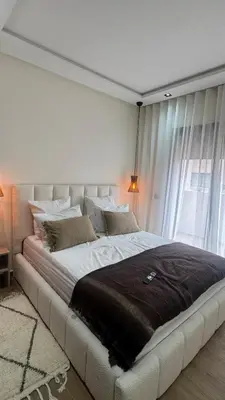 a large white bed in a room with a window at Cozy apartment Kenza Menara Garden 2 - 2 rooms in Marrakech