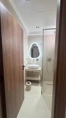 a bathroom with a sink and a glass shower at Cozy apartment Kenza Menara Garden 2 - 2 rooms in Marrakech