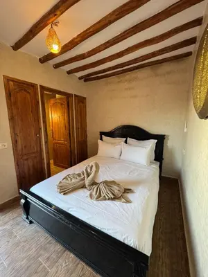 a bedroom with a bed with white sheets and pillows at Duplex Bahia Palace in Marrakech