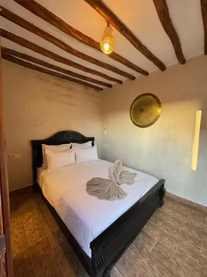 a bedroom with a large bed with white sheets at Duplex Bahia Palace in Marrakech