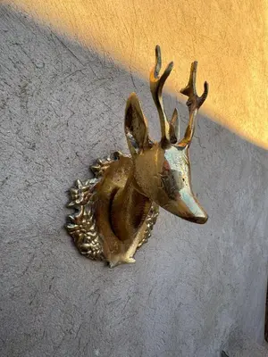 a bronze deer head with antlers on a wall at Duplex Bahia Palace in Marrakech