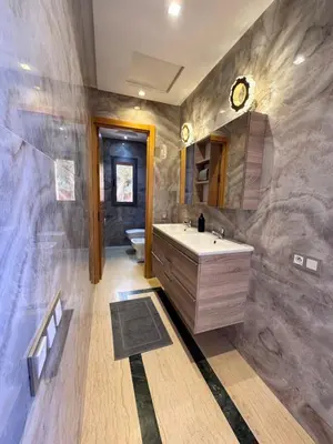 a bathroom with a sink and a toilet in it at Villa Akenza piscine privée Marrakesh in El Rhechat