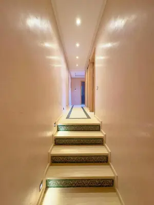 a hallway with stairs leading up to a door at Villa Akenza piscine privée Marrakesh in El Rhechat
