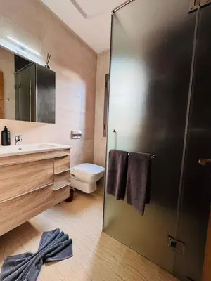 a bathroom with a shower with a sink and a toilet at Villa Akenza piscine privée Marrakesh in El Rhechat