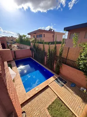 a swimming pool on the side of a building at Villa Akenza piscine privée Marrakesh in El Rhechat