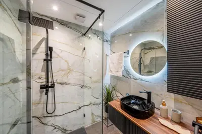 a bathroom with a shower with a sink and a mirror at Gueliz Signature Terrasse and Comfort in Marrakech
