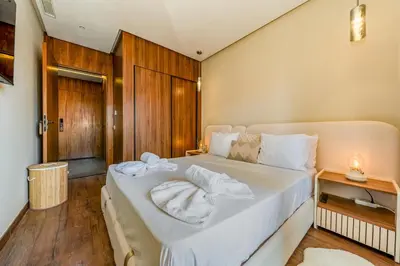 a bedroom with a large bed with white sheets at Gueliz Signature Terrasse and Comfort in Marrakech