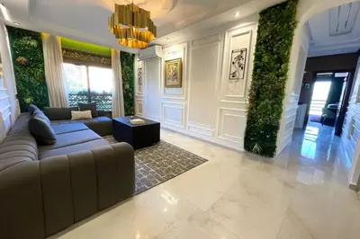 a living room with a couch and ivy on the walls at Caprice Royal - 3 Bedroom Luxury Apartment with Pool - Hivernage in Marrakech
