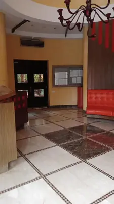 a room with a lobby with a red couch and tile floors at Marrakech garden lilla in Marrakech