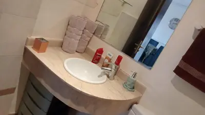 a bathroom with a sink and a mirror at Marrakech garden lilla in Marrakech