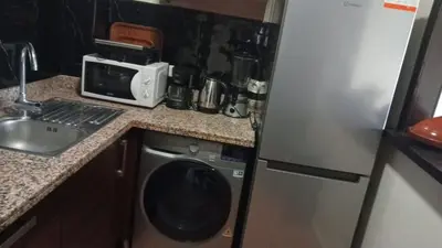 a kitchen with a washing machine and a microwave at Marrakech garden lilla in Marrakech