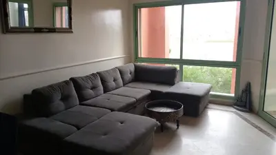 a living room with a couch and a large window at Marrakech garden lilla in Marrakech