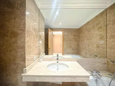 a bathroom with a sink and a tub at Confort Signature - Piscine, balcon & parking in Marrakech