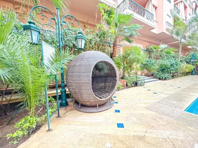 a bird bath in a courtyard with plants at Confort Signature - Piscine, balcon & parking in Marrakech