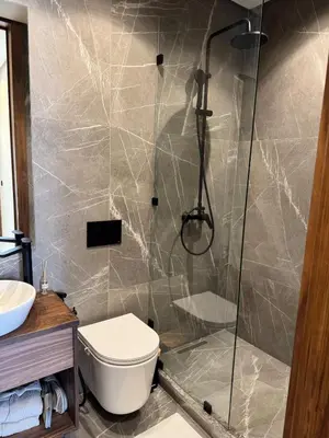 a bathroom with a shower and a toilet at Refined apartment with rooftop pool in Marrakech