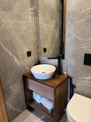 a bathroom with a sink and a toilet at Refined apartment with rooftop pool in Marrakech