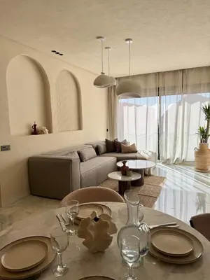 a living room with a couch and a table at Refined apartment with rooftop pool in Marrakech