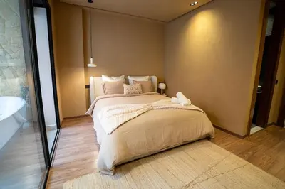 a bedroom with a large bed and a mirror at Spacious duplex Private HEATED pool Jacuzzi in Marrakech