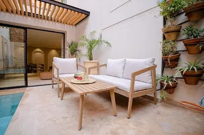 a patio with a table and two chairs and a table and a table at Spacious duplex Private HEATED pool Jacuzzi in Marrakech
