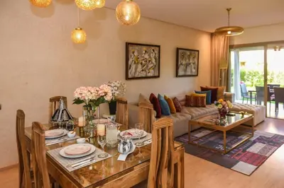 a living room with a table and a couch at Prestigia Jade in Marrakech