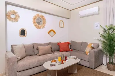 a living room with a couch and a table at Lalla Homes 369 in Marrakech