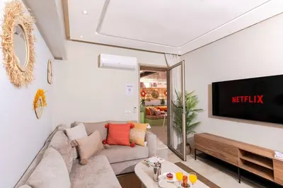 a living room with a couch and a tv at Lalla Homes 369 in Marrakech
