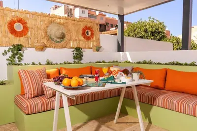 a table and a couch on a patio at Lalla Homes 369 in Marrakech
