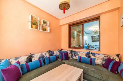 a living room with a couch and a table at Spacious & Modern Guéliz Apart - 5 min to Airport in Marrakech