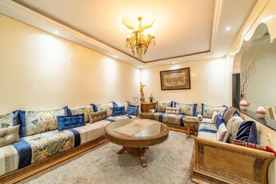 a living room with couches and a chandelier at Spacious & Modern Guéliz Apart - 5 min to Airport in Marrakech