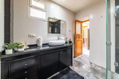 a bathroom with a sink and a mirror at Spacious & Modern Guéliz Apart - 5 min to Airport in Marrakech