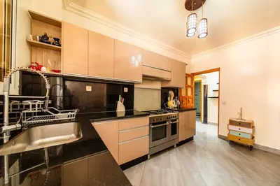 a large kitchen with a sink and a stove at Spacious & Modern Guéliz Apart - 5 min to Airport in Marrakech