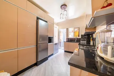 a large kitchen with a stainless steel refrigerator at Spacious & Modern Guéliz Apart - 5 min to Airport in Marrakech