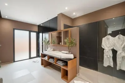 a bathroom with a sink and a mirror at Rixos Palm villas with a heated private pool & garden in Marrakech