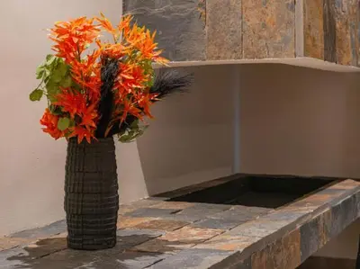 a vase filled with orange flowers sitting on a counter at Rixos Palm villas with a heated private pool & garden in Marrakech
