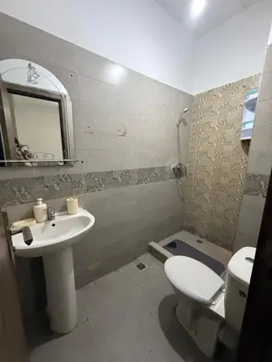 a bathroom with a sink and a toilet and a mirror at Marrakech appartement in Marrakech