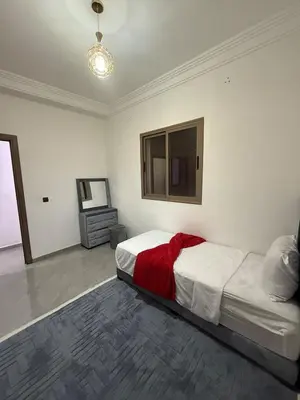 a bedroom with a bed with a red blanket at Marrakech appartement in Marrakech