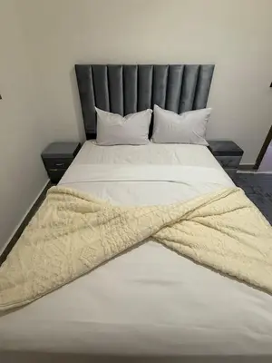 a large white bed with a blanket on it at Marrakech appartement in Marrakech