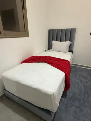 a bedroom with a bed with a red blanket at Marrakech appartement in Marrakech
